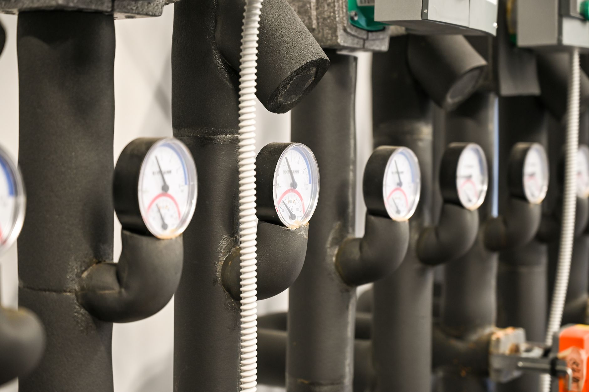 Insulated pipes with pressure gauges in a facility